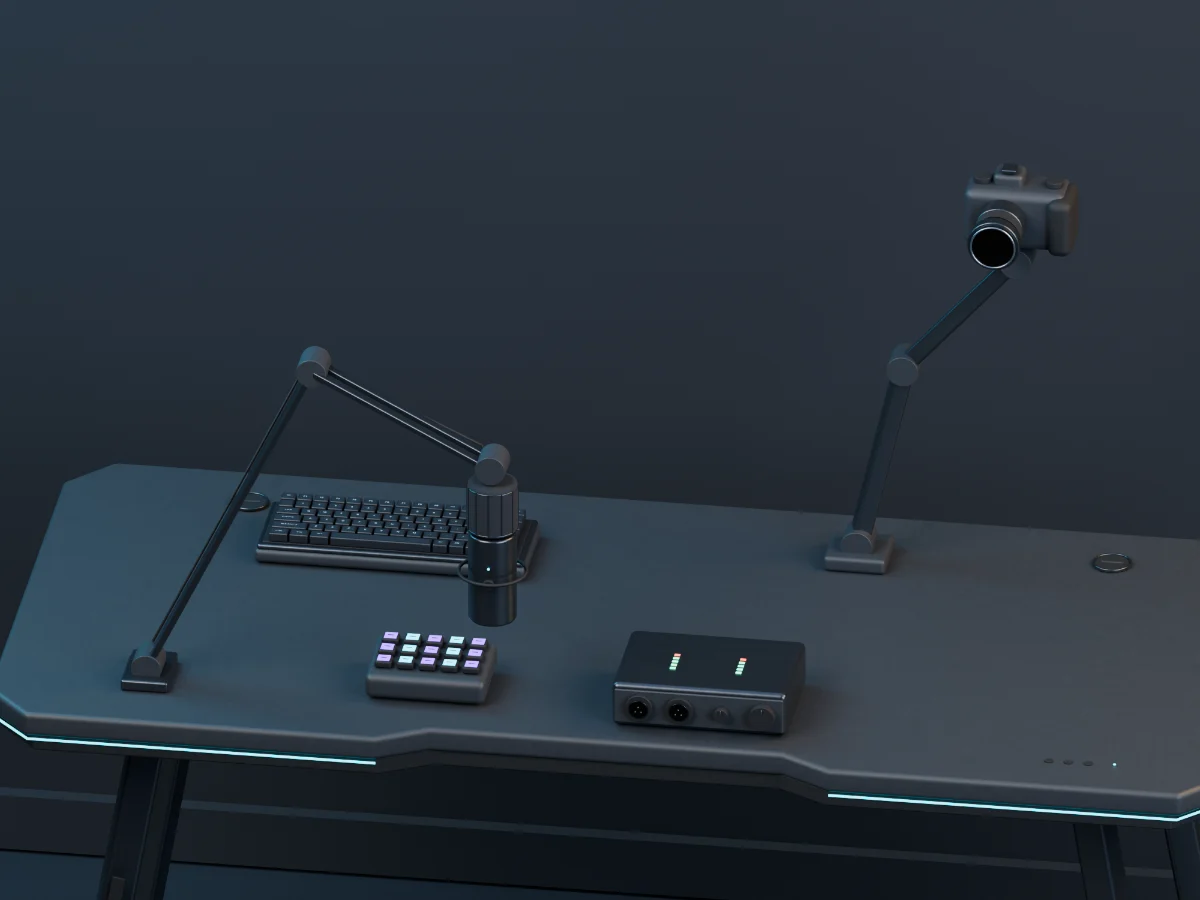 Included boom microphone, desk-mounted camera, macro pad and audio interface on the graphite desk