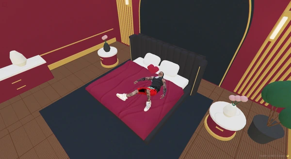 A player lying on a burgundy bed in the furnished showroom.